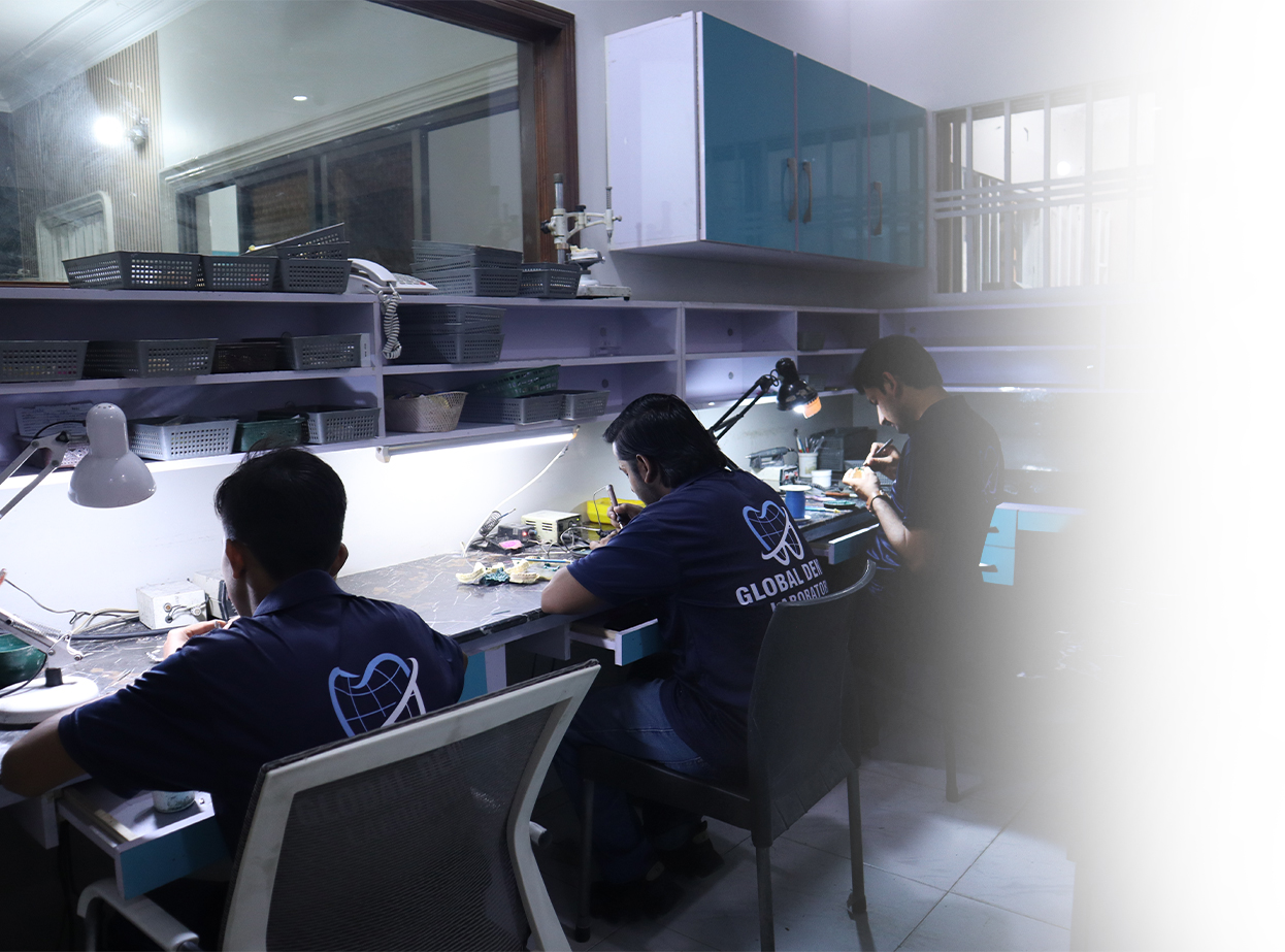 Employees working in a global dental laboratory